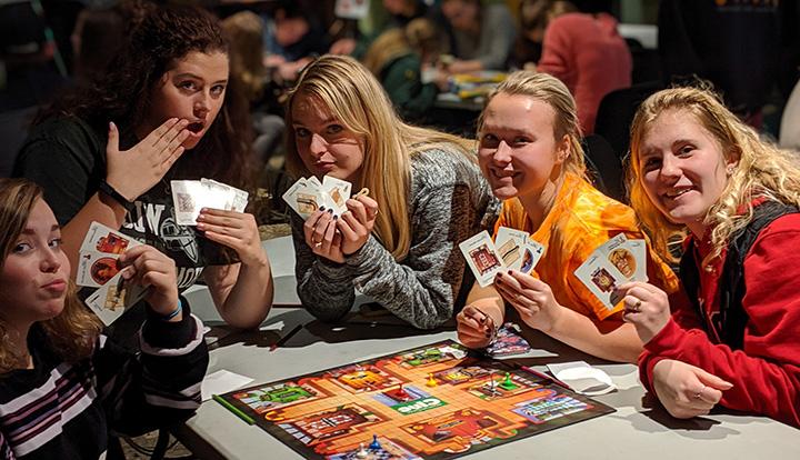 Students playing Clue board game during Game Night in WU